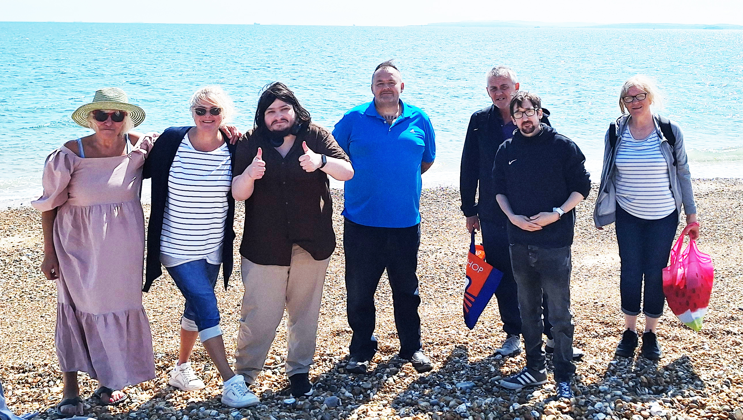 A group of four male clients and three female clients at Hayling Island beach 